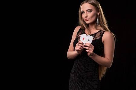 93788489-young-beautiful-woman-playing-in-casino-girl-holding-the-winning-combination-of-poker-cards-two-aces